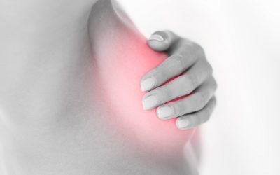 health and medicine concept - woman checking breast for signs of cancer